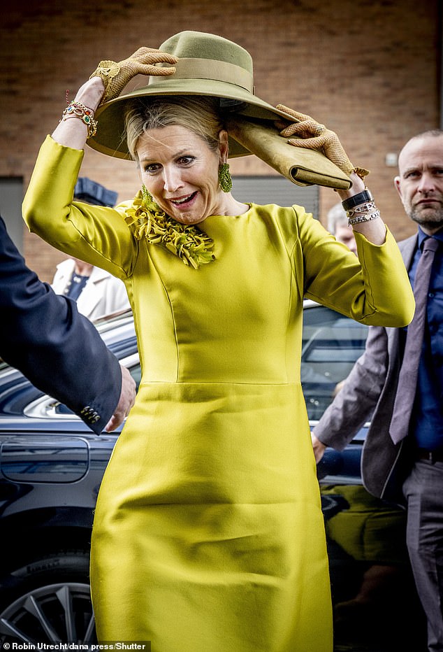 Queen Maxima of the Netherlands faced a windy start to her trip to the Taal aan Zee Foundation in The Hague on Wednesday and struggled to hold on to her hat.