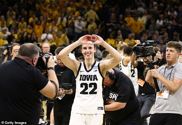 The gesture Clark makes at the end of games is seen here, with the former Iowa star smiling