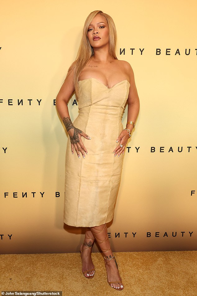 Rihanna, 36, put on a busty display in a sand-colored sheath dress at a launch event for her brand Fenty Beauty in Los Angeles on Friday.