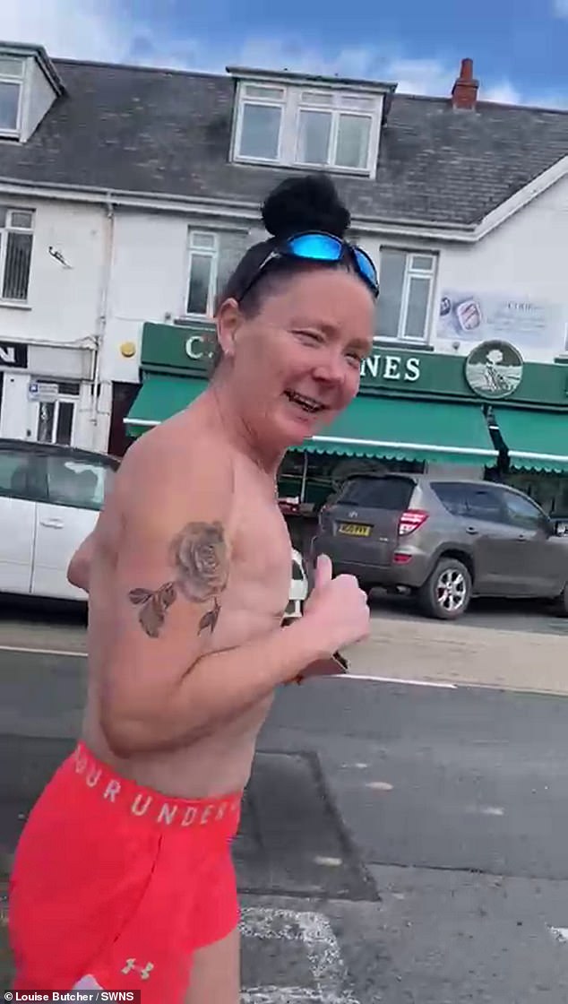 Louise Butcher, 50, often runs topless around her Devon village to reduce the stigma around the bodies of breast cancer survivors.  This week she is preparing to run the London Marathon.