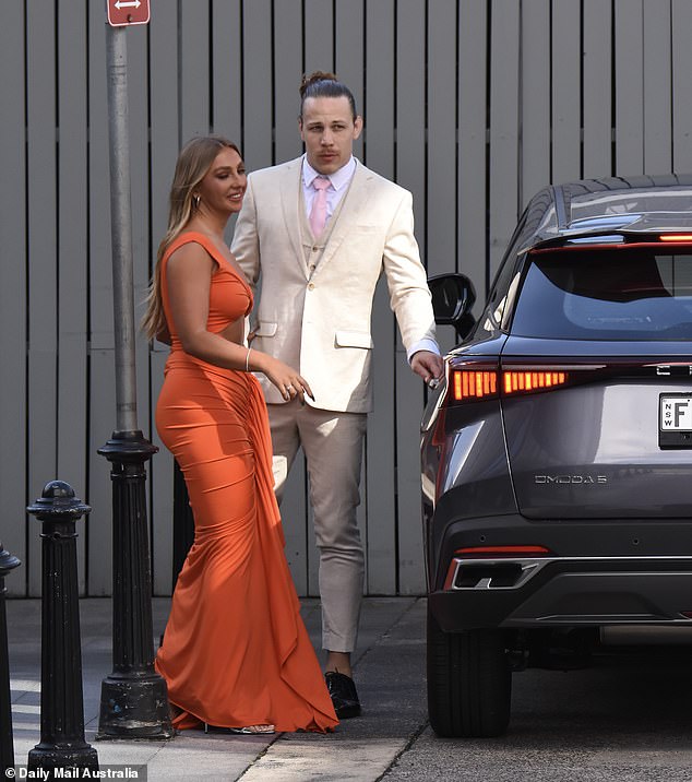 Jayden and Eden were all smiles as they got out of their car together, with Eden wearing a figure-hugging bright orange dress and Jayden wearing a cream-colored suit.  Both in the photo