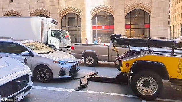 A tow truck driver in San Francisco was seen on video trying to tow a car while the driver was still inside