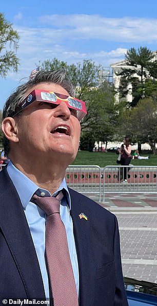 Sen. Joe Manchin, DW.V., watches the 2024 solar eclipse