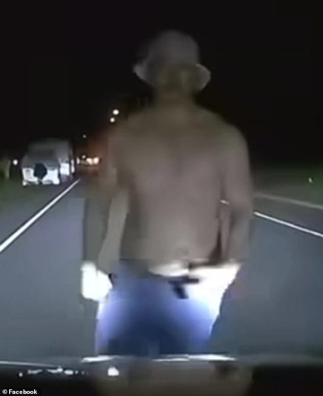 Shirtless man on dimly lit Brisbane road jumps onto car