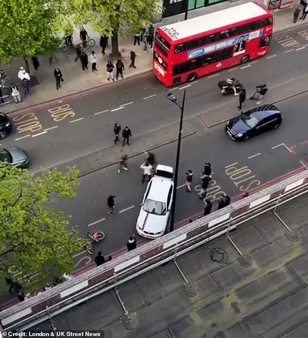 This is the shocking moment men fought with what appears to be a machete on a busy London road after the gunman tried to use their car as a battering ram.