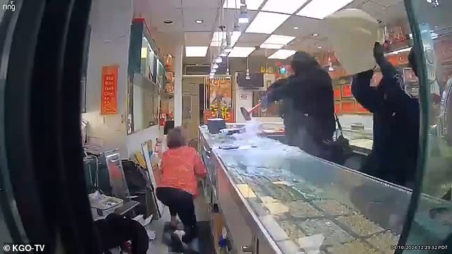 The eight robbers armed with hammers broke into Phuong Jewelry in Oakland's Chinatown on Wednesday, while store owner Diane hid behind the display case.