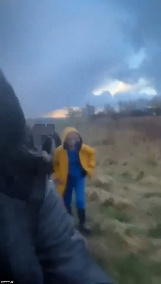The images show a group of teenagers shouting insults at a woman as she walked, dressed in a yellow raincoat and wellies.