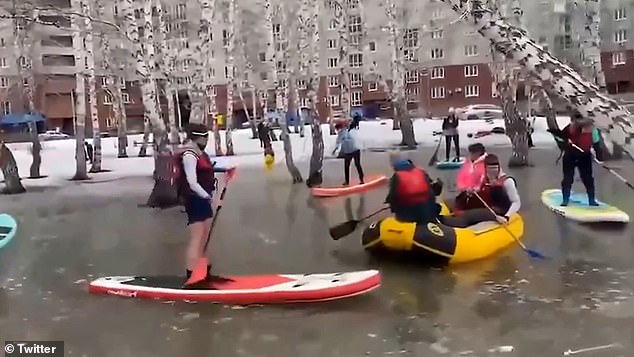 Residents of Omsk, Siberia, were seen paddling through a flooded yard.