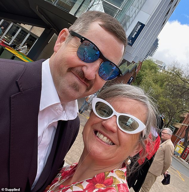 Stuart Brand died from a suspected self-inflicted gunshot wound in Adelaide's Outer Harbor shortly before 6pm on Monday, amid reports that members of the public witnessed the horrific scene (pictured with his wife).