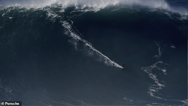 Spectacular aerial footage shows Sebastian Steudtner taking down huge foaming waves in Nazaré, Portugal