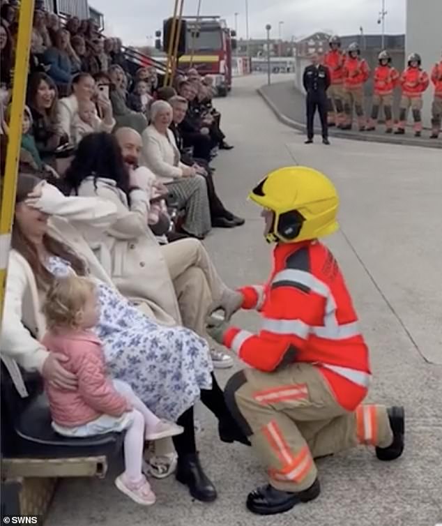 Greater Manchester Fire Department has shared a clip of the special moment a newly qualified firefighter proposed to his girlfriend at his passing out parade.