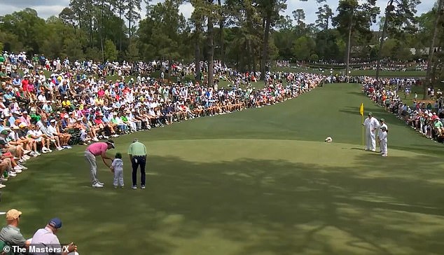 With the help of Bubba Watson (left), the youngster made a putt from the other side of the green.