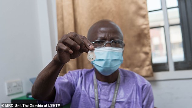 The findings suggest that the patches do not need to be administered by trained medical staff, which could take responsibility away from GPs. In the photo, a Gambian healthcare worker holds a microarray patch of the type used in the study.