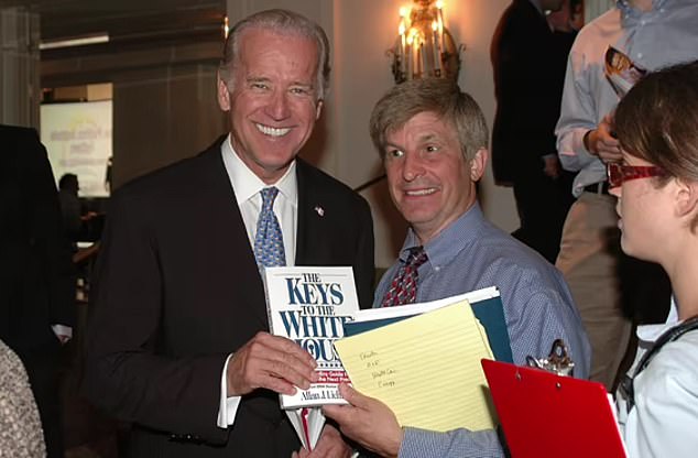 Joe Biden is seen with Allan Lichtman, holding a copy of his book.  Lichtman believes signs show 2024 will trend in Biden's favor