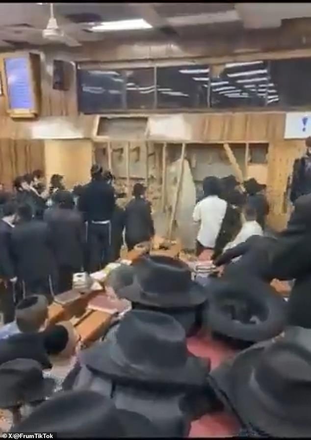 The wooden walls of the synagogue are shown destroyed, in scenes that the rabbi said were 