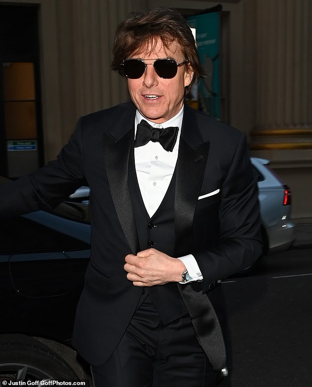 Tom looked dapper in a black tuxedo which he paired with a matching bow and a white shirt, while shielding his eyes behind a pair of dark sunglasses.