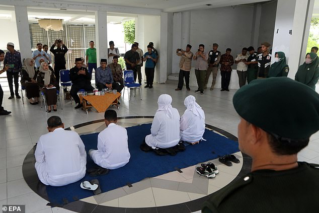 Acehnese couples receive a religious lecture before being flogged in front of the public for violating Sharia law, in Banda Aceh, Indonesia.