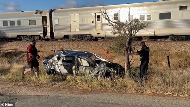 Two 17-year-olds are lucky to be alive after their car overturned after crashing into The Ghan at a junction (pictured)