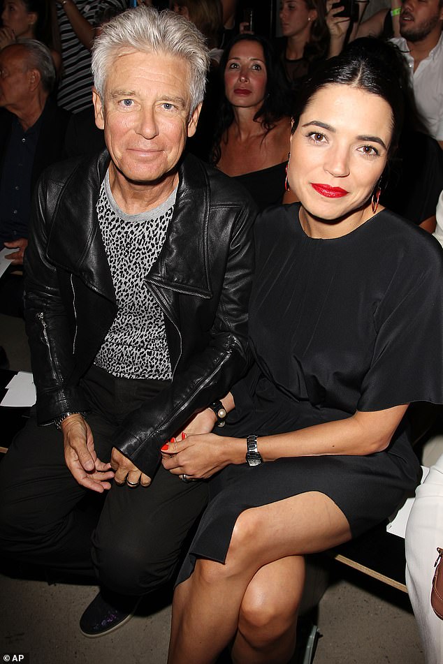 U2 star Adam Clayton has revealed that he and his wife Mariana Teixeira de Carvalho have divorced after more than a decade (pictured together in 2014).