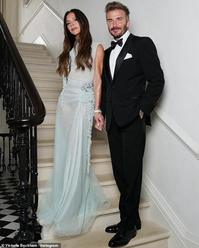 Victoria Beckham looked sensational in a floor-length semi-sheer blue dress as she posed alongside her husband David ahead of her 50th birthday celebration with her family on Saturday.