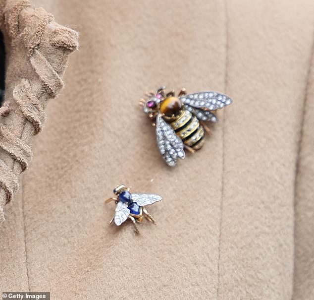 Just buzzing...this very busy royal sports a large bumblebee with rubies for eyes and a sapphire bee brooch that some might mistake for a bluefly!
