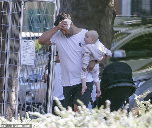 Jimmy Bartel had his hands full when he stepped out with his three children last week.  The AFL star looked a little frazzled as he carried Paloma, who he welcomed with his girlfriend Amelia Shepperd last year, in one arm and a takeaway coffee in his free hand.