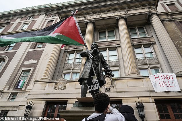 The occupation was an escalation of unrest that has been rocking Colombia since April 17, when a camp emerged.  Pictured: A Palestinian flag flies from a statue of Alexander Hamilton in front of Hamilton Hall on April 30.