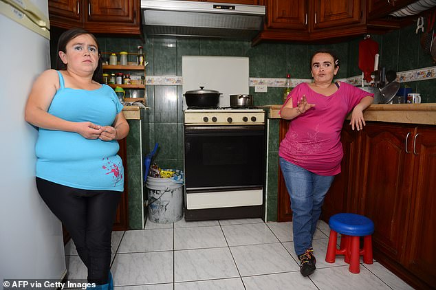 Maritza (left) and Lugartda Valarezo (right), in their kitchen in Quito, Ecuador, in 2014. The Valarezo sisters are patients of the study's lead co-author Jaime Guevara-Aguirre, who has studied Laron syndrome for more than two decades.