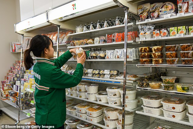 A worker replenishes rice balls at a 7-Eleven store in Tokyo, Japan;  The head of the brand's Australian operations said he has a lot to learn from Japanese 7-Eleven.