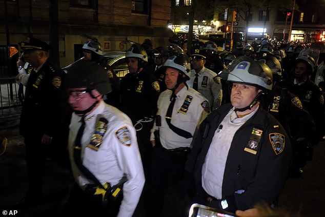 Members of the New York Police Department's strategic response team advance toward the entrance to Columbia University just before the raid.