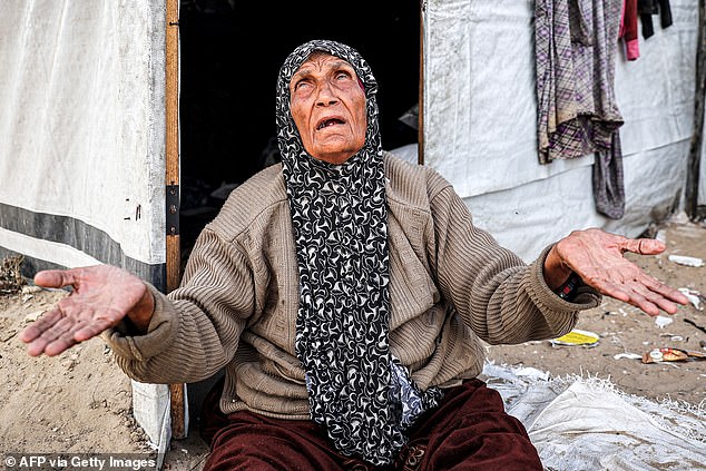 An elderly Palestinian sits in front of her makeshift home in Rafah, in the southern part of the Gaza Strip, on Tuesday.  Palestinians with strong ties to the United States will soon be able to apply for resettlement in the states