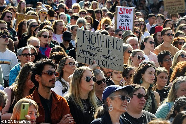 Protesters are shown marching in solidarity during the 'No More!' speech.  National demonstration against violence in Melbourne