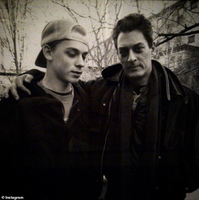 Daniel Auster appears in a photo with his father Paul, in a shot from his adolescence.