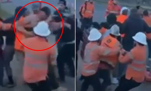 In the footage, one man forcefully attempts to break the line from the front while another approaches from behind in an effort to separate the workers' interlocking arms.