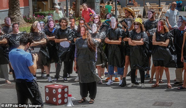 Members of the 'Canaria se exhausts' movement protest against the construction of a hotel near La Tejita beach and other mass tourism infrastructure, in La Laguna, on the Spanish Canary island of Tenerife, on April 13, 2024.