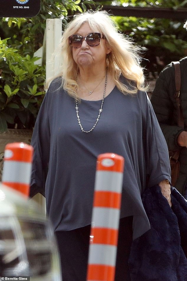 Judy stepped out wearing a flowy gray top with a pair of black pants, which she accessorized with a Chanel necklace and oversized sunglasses.