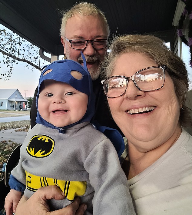 Lora Stahl, 56, of Nebraska, pictured here with her husband Herb and grandson, is one of more than 54,000 people who say J&J's baby powder gave them cancer.  She previously suffered from ovarian cancer.