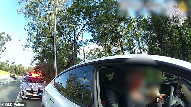 The Tesla driver (pictured being pulled over for the second time in three hours) was fined $750 and disqualified from driving for at least two years.  No conviction was recorded