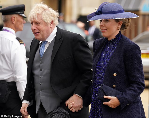 Former Prime Minister Boris Johnson and his wife Carrie Johnson arrive at the coronation of King Charles III and Queen Camilla in May 2023.