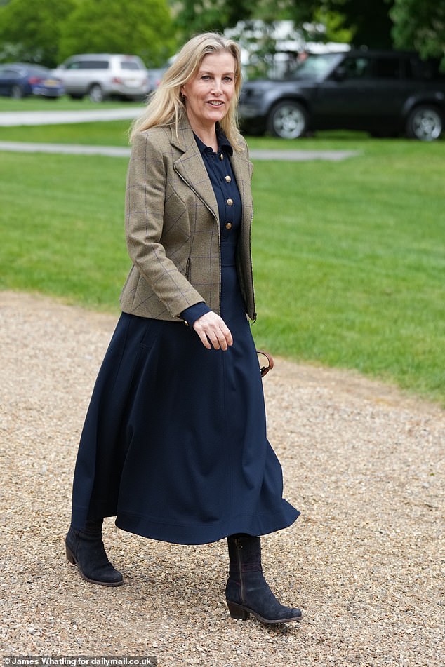 Sophie, 59, looked effortlessly chic in a navy dress, embellished with gold buttons, and a checked jacket as she enjoyed the event loved by her late mother-in-law, the Queen.