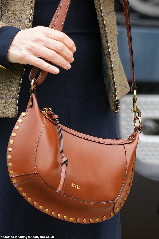 The royal carried a £695 leather bag as an accessory and paired the look with blue suede boots.