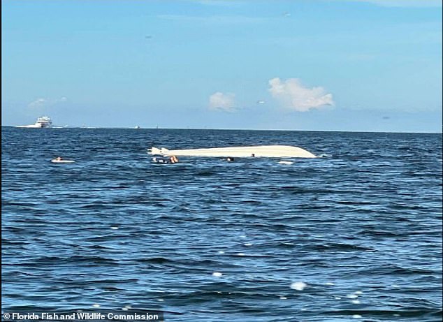 The boat capsized and all 14 people on board ended up in the water.