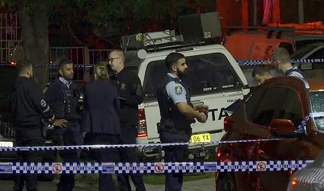 Police are seen at the scene of an alleged drive-by shooting in Merrylands on Tuesday.