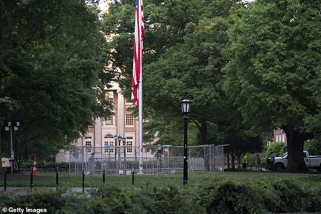 The American flag is surrounded by a temporary barrier at the University of North Carolina's Polk Place on May 1 in Chapel Hill, North Carolina.