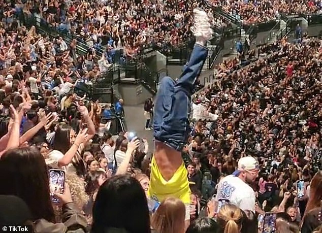 Another disruptive fan attempted to do a handstand in the raised seating area, but lost his balance and fell onto another fan.