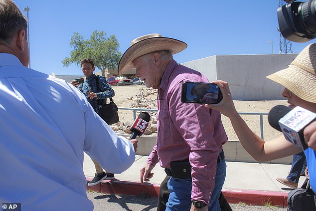 Reporters follow Kelly as he leaves the Santa Cruz County Courthouse.