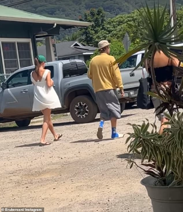 Hailey looked effortlessly chic in a green baseball cap and white dress. Meanwhile, Justin looked casually cool in a Nike bucket hat, a yellow sweatshirt, and gray shorts.