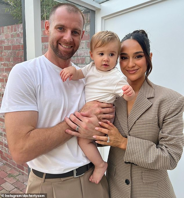 Docherty, 30, has beaten cancer twice and is recovering after his third knee reconstruction in March (pictured with wife Natalie and daughter Ruby).