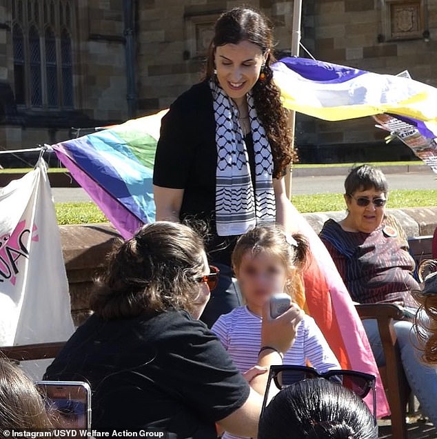 Dr. Abdel-Fattah is shown smiling at a girl, who appeared to be as young as four, as he spoke into a microphone at Friday's event.