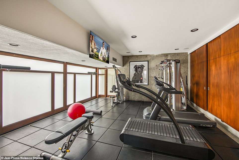 The house is also gated with a long driveway and a closed garage, which has been transformed into a gym.